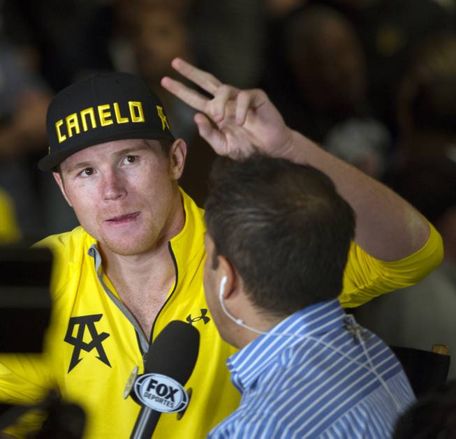 Canelo Alvarez signals fans during an interview following his weigh-in at the MGM Grand Arena on Friday, March 07, 2014.  L.E. Baskow